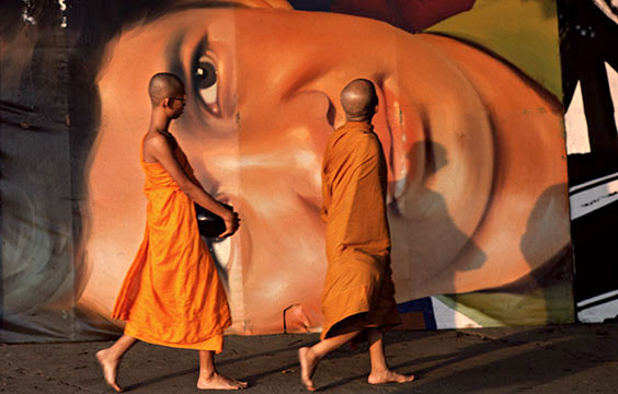 Photo of monks in front of a Richard Gere American Gigolo Poster in Bangkok