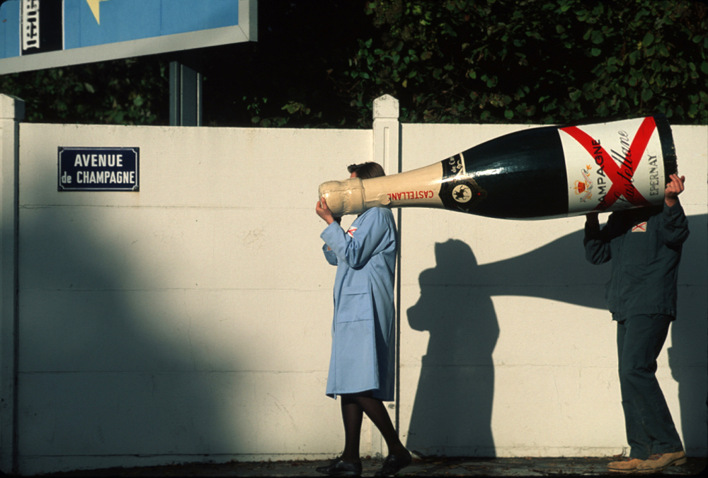 Photo of a giant champagne bottle being carried in Champagne, France